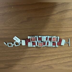 NWT. Handmade BC/artisan silver bracelet/toggle closure/red leather woven insert